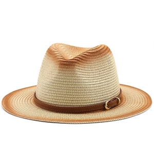 Detail of gradient woven straw hat with brown leather band and golden metal buckle