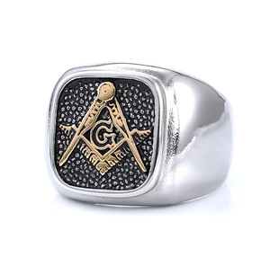 Macro view of Masonic G symbol on vintage gold and silver stainless steel ring