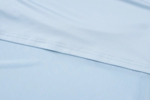 Close-up of light blue mesh fabric stitching and breathable texture on the slim fit set