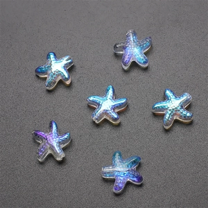 Macro shot of 7 blue-purple iridescent starfish-shaped glass crystal charms for DIY jewelry