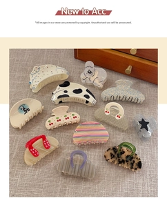 Various acetate hair claws featuring cherry, polka dot, and leopard print patterns