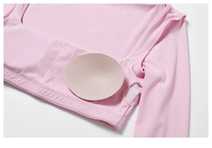 Detail showing the removable chest pads and soft inner lining of the pink yoga top