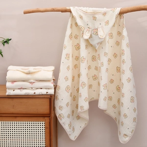 Hooded baby poncho towel in soft cotton gauze featuring cute cartoon bear and heart prints