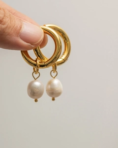 Close-up of gold hoop earrings with natural freshwater pearl pendants for women