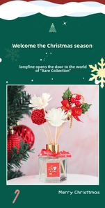 Detailed Christmas reed diffuser set with red ribbon, bells, berries and white sola flowers