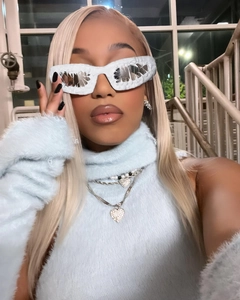 Close-up of avant-garde white textured sunglasses worn by model with Y2K hip-hop style