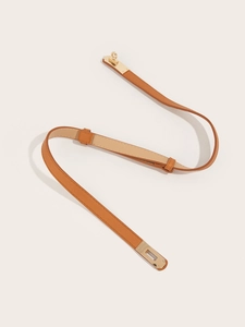 Detail of tan crossgrain leather belt with a classic golden metal twist lock buckle