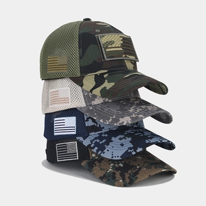 Detail of mesh tactical baseball caps featuring American flag patches and camo patterns