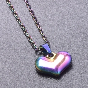Macro view of 3D heart pendant necklace with iridescent 18k gold plated finish