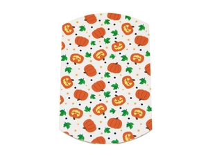 Macro detail of Halloween pillow candy box featuring orange pumpkin and green leaf prints