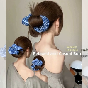 Blue and white striped scrunchie detail on a messy bun hairstyle for women