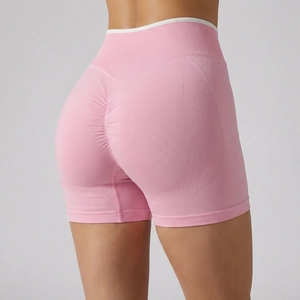 High-waist seamless scrunch butt yoga shorts in vibrant pink with elastic ribbed waistband