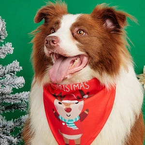 Christmas dog bandana with festive reindeer print and text on soft red polyester fabric