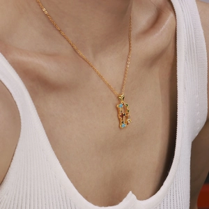 Gold letter B pendant necklace featuring colorful cubic zirconia on a dainty chain
