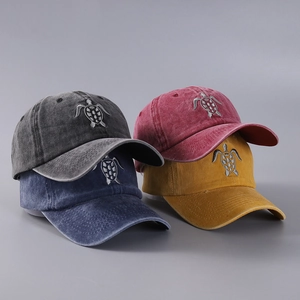 Detailed view of silver sea turtle embroidery on cotton washed baseball caps in four colors