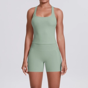 Detail of sage green yoga set showing racerback tank top and high waist side pocket shorts