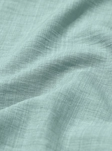 Macro texture of breathable linen fabric in light mint green for men shirt