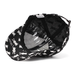 Detail of black baseball cap interior with white rabbit print and care label