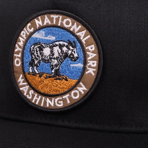 Close-up of Olympic National Park embroidery detail on black cotton hip-hop flat cap
