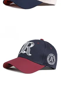 Detail of navy blue and burgundy baseball cap with 3D R embroidery and side badge