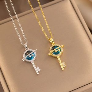 Starry planet key necklaces in gold and silver colors displayed in a brown jewelry box