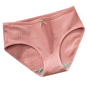 Detailed view of pink ribbed cotton panties with a small beige bow on the waistband