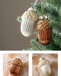 Detailed close-up of cream and bronze acorn ornaments with glitter on a Christmas tree