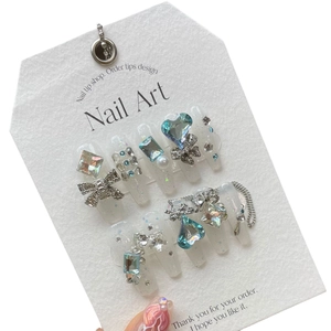 Luxurious white bridal press-on nails with blue crystal hearts and silver bows