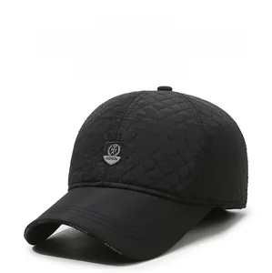 Detail of black winter baseball cap with diamond quilting and HT FASHION shield badge