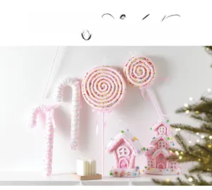 Pink Christmas ornaments collection featuring candy canes and gingerbread house decor