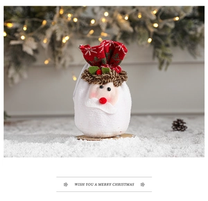 Detail of Santa plush drawstring gift bag with knitting pattern and festive ornaments