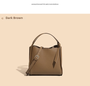 Detail of dark brown leather bucket bag showing lychee grain texture and knotted handle