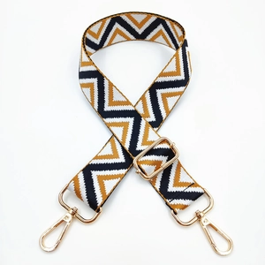 Adjustable bag strap with yellow and black zigzag patterns and gold metal swivel hooks