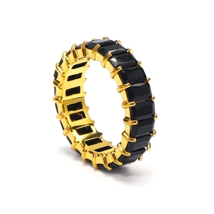 Detailed side view of golden ring featuring rectangular black zircon stones set in a band