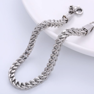 Polished 5mm stainless steel silver Franco chain bracelet with lobster clasp on white tray