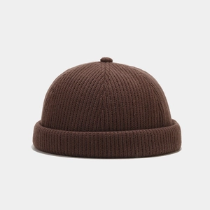 Detailed texture of a dark coffee knit Miki hat with thick rolled edge and top pompom