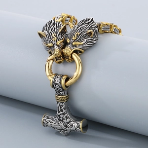 Detail of Viking Thor Hammer Mjolnir pendant with golden wolf heads on Byzantine chain