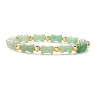 Green natural stone bamboo bead bracelet with gold accents on white background