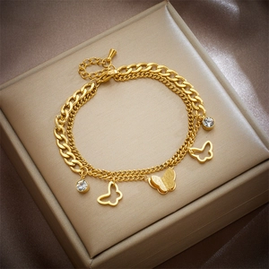 Gold double-layer butterfly pendant bracelet with cubic zirconia on a jewelry box
