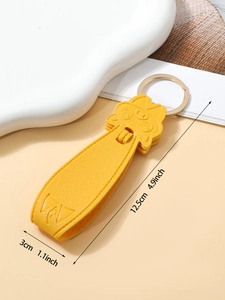 Detail shot of yellow PU leather cat keychain with dimensions 12.5cm by 3cm and gold ring