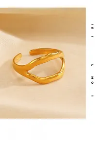 Detailed view of irregular wavy 18K gold-plated open ring on soft white fabric background