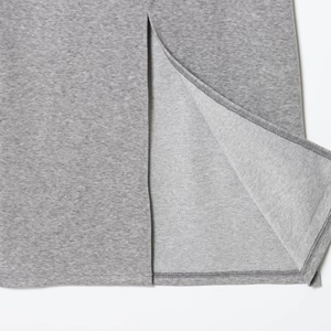 Close-up of gray knit polo suit featuring slit hem design and cotton fabric texture