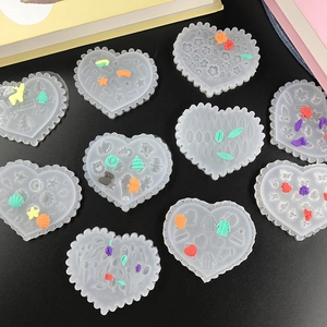 Detailed view of 10 heart-shaped silicone molds with various miniature patterns