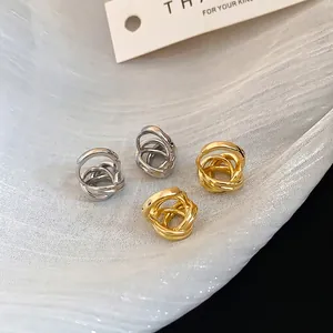Minimalist twisted hoop earrings in gold and silver finish with multi-layered design