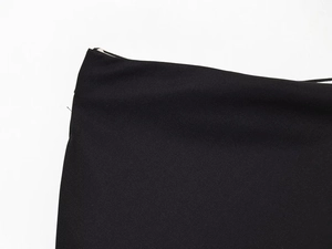 Close-up of black twill fabric texture showing detailed diagonal weave pattern
