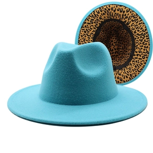 Detail of turquoise fedora with wide brim featuring a striking leopard print lining