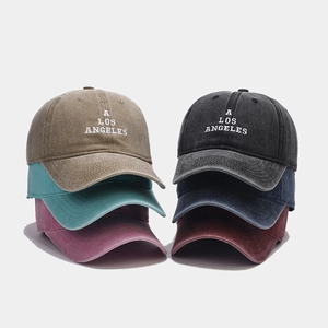 Close-up of vintage washed cotton baseball caps with embroidered Los Angeles logo detail