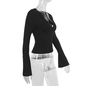 Detail of elegant black deep V-neck top with intricate lace trim and slim fit sleeves
