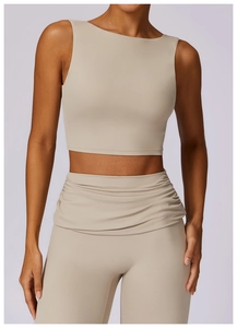 Detail of beige yoga set featuring a ruched high-waist legging and sleeveless crop top