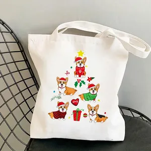 White Corgi canvas tote bag with Christmas cartoon dog print on a metal chair